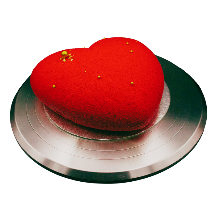 Transylvania Cakes' Batticuore x Chocolate & Baileys heart-shaped cake, a luxurious blend of rich chocolate sponge and velvety Baileys infused ganache, crowned with a smooth layer of caramel mousse and a layer of sprayed red chocolate, promising an indulgent experience with every bite.