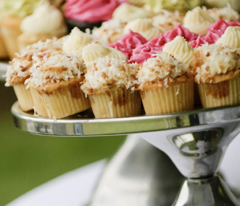 Assorted cupcakes and sweets on display at a christening Candy Bar, showcasing Transylvania Cakes' attention to detail and quality ingredients.